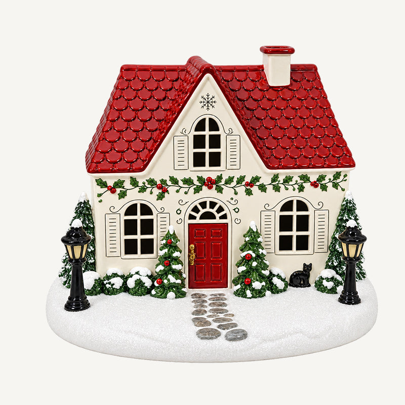 🎄✨ Diffuseur « La maison de Noël de Mistletoe Lane » — Diffuseur festif représentant un village de Noël avec des fenêtres illuminées et une charmante brume de cheminée